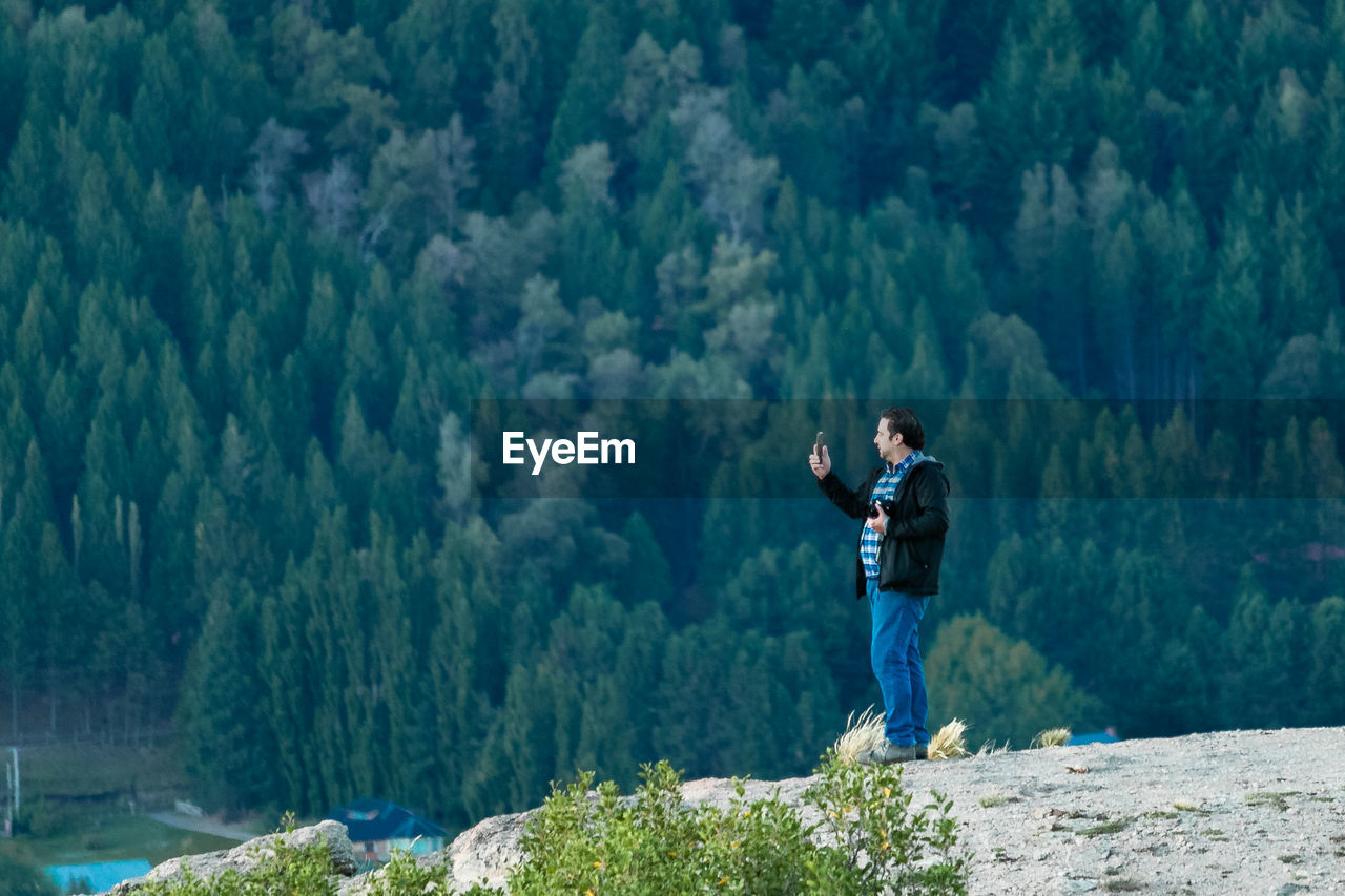 Rear view of man standing on rock