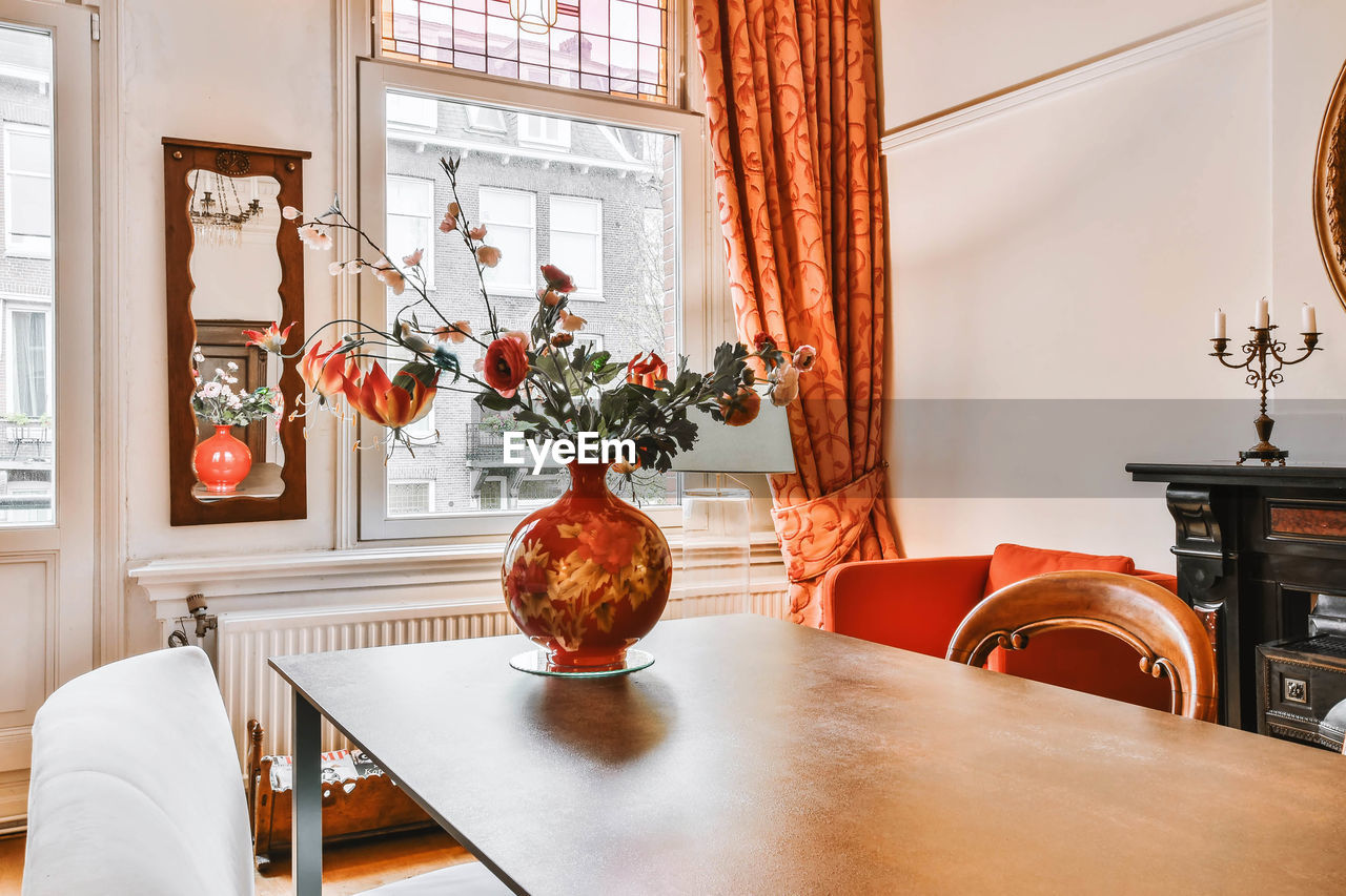 Flower vase on table at home