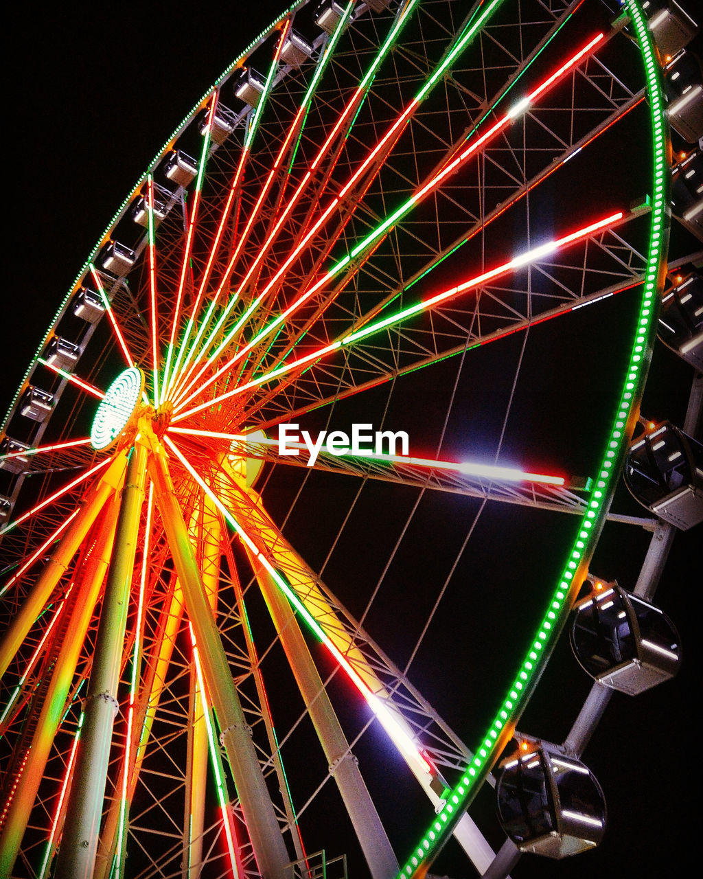 Low angle view of illuminated ferris wheel at night