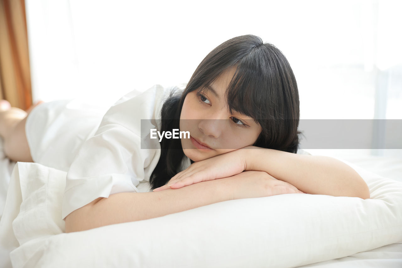 young woman sleeping on bed
