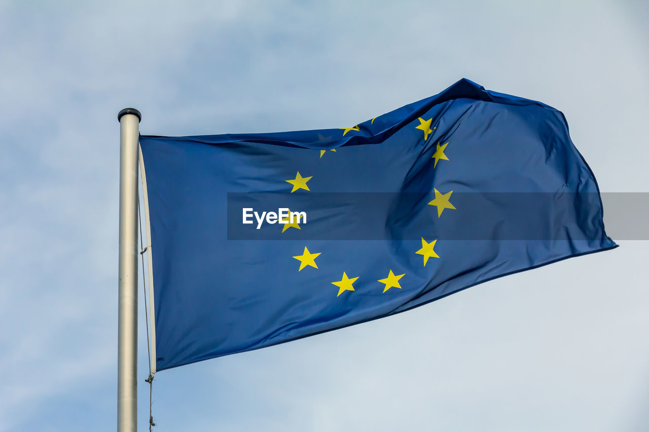 Eu, europe, european union flag waving on blue sky background