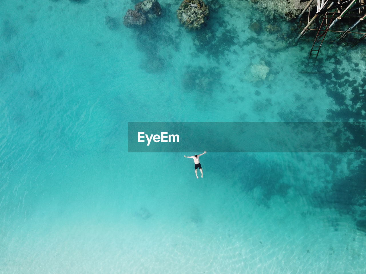 Aerial view of man swimming on sea