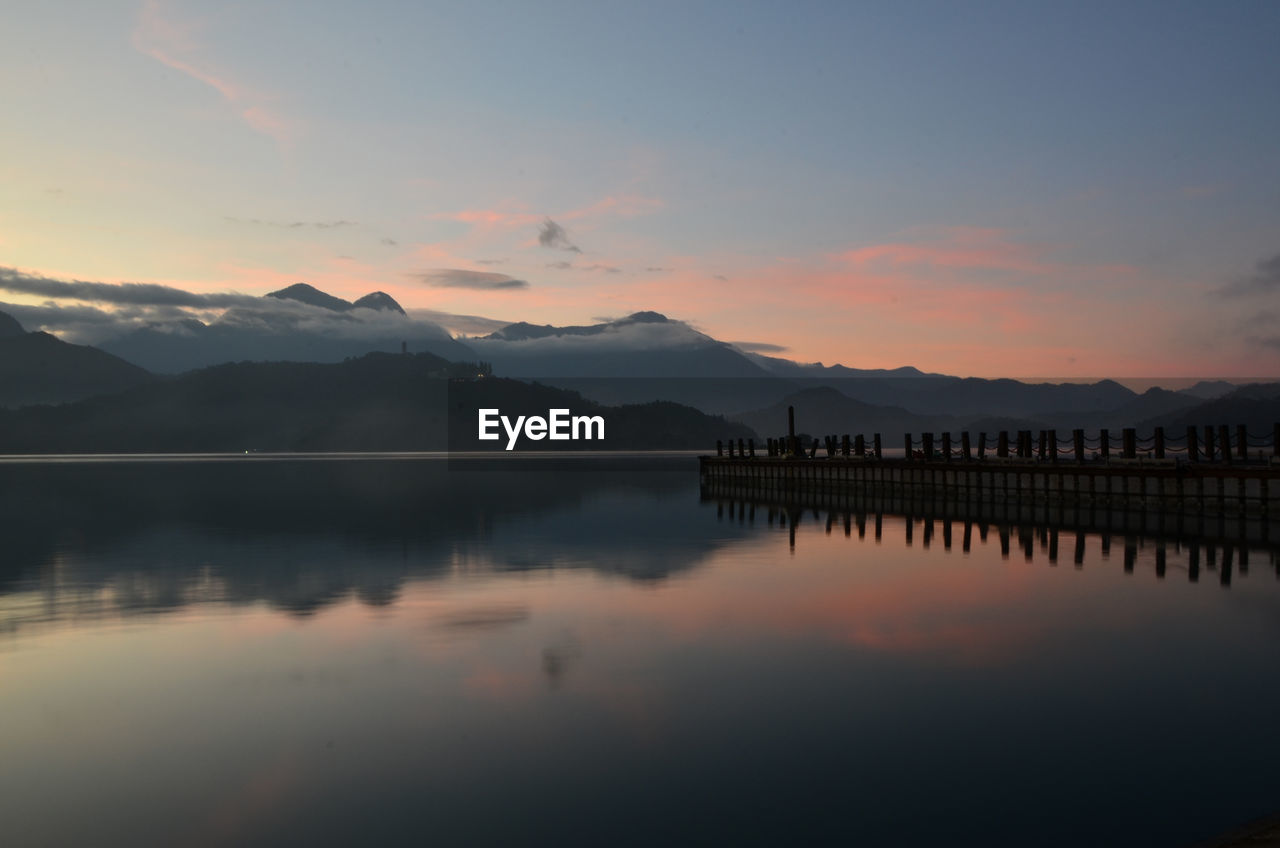 Scenic view of lake against sky during sunset