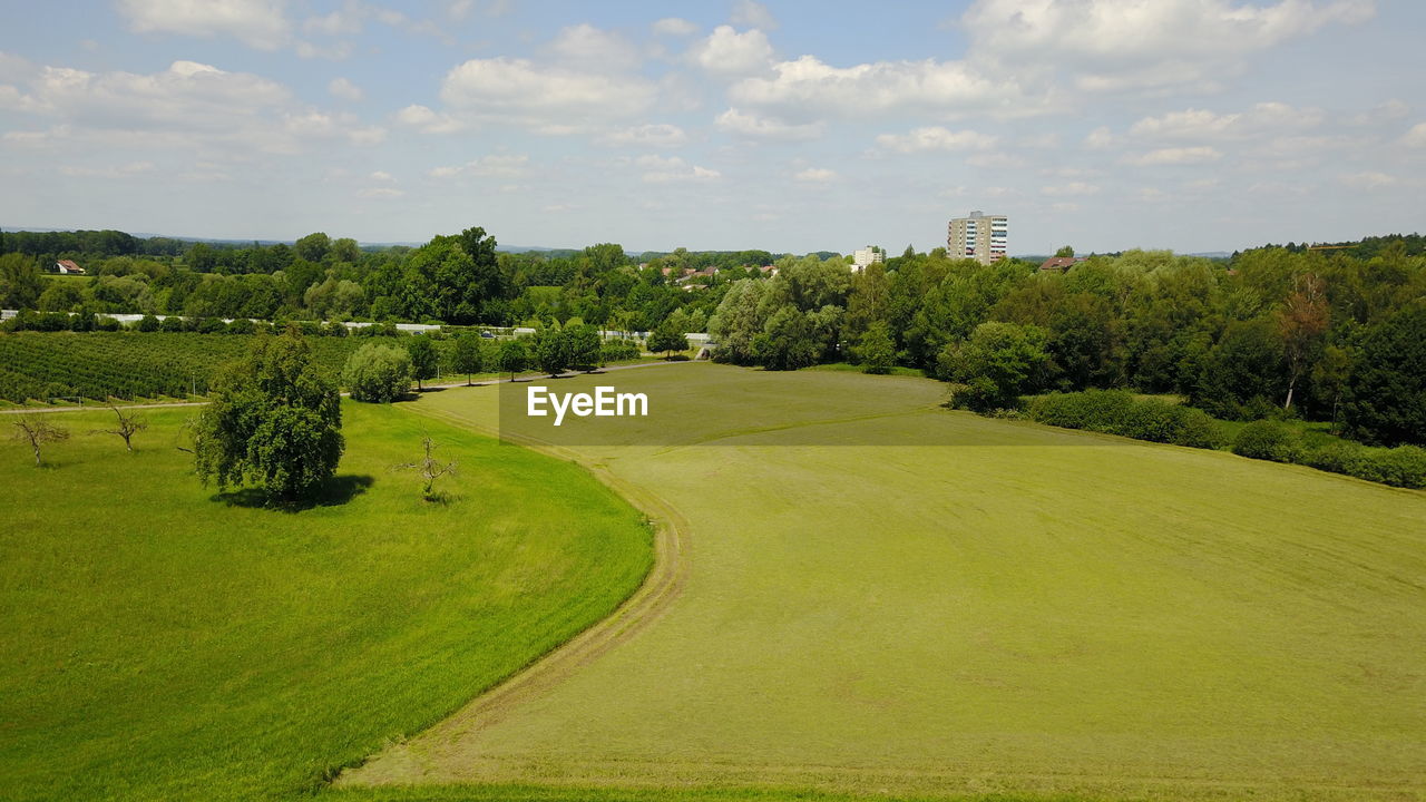 Scenic view of green landscape against sky