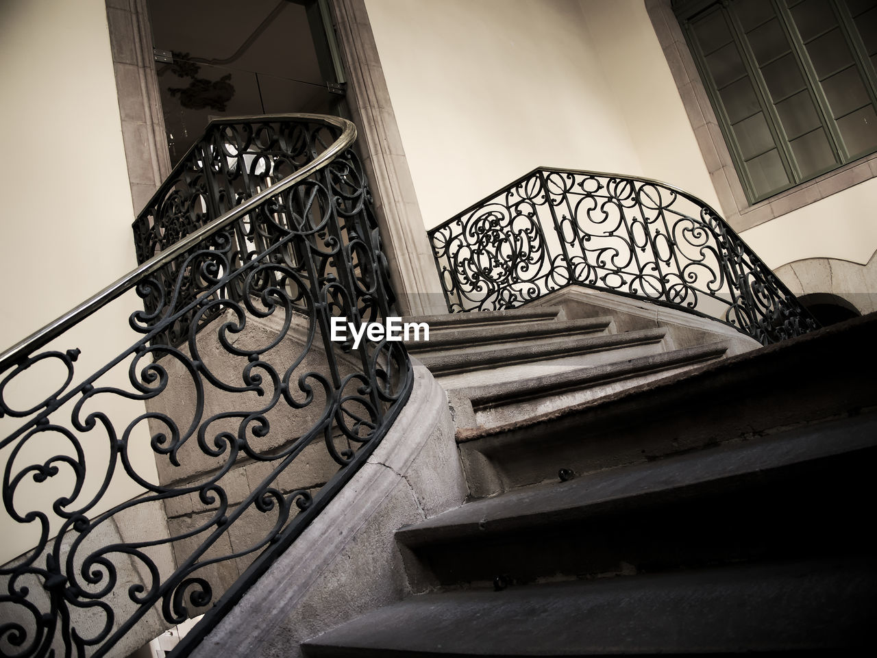 LOW ANGLE VIEW OF SPIRAL STAIRS AGAINST SKY