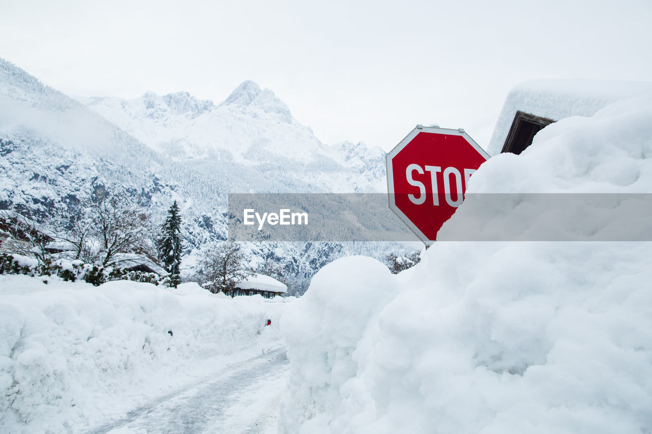 Road sign is covered by snow