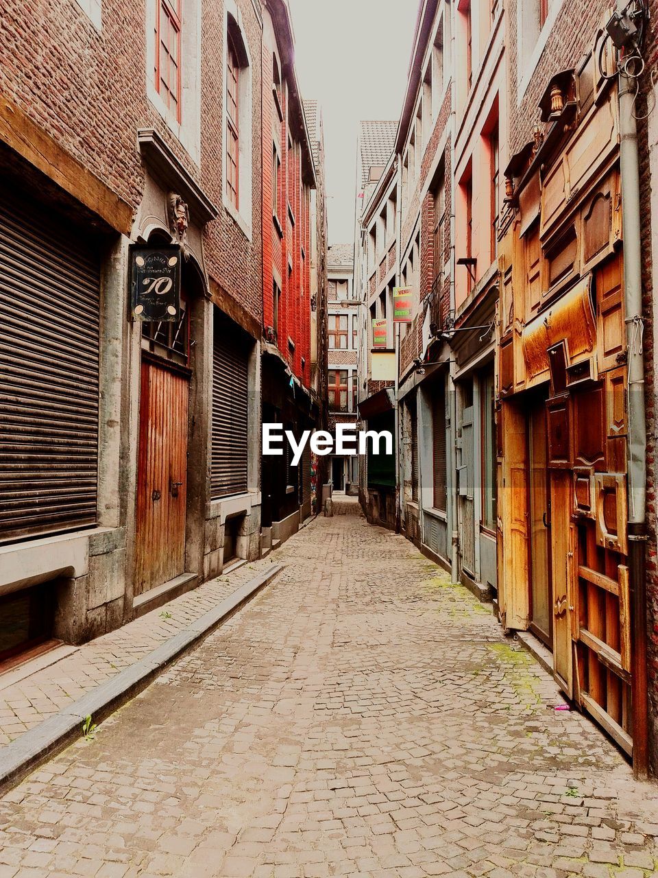 NARROW STREET LEADING TOWARDS RESIDENTIAL BUILDINGS