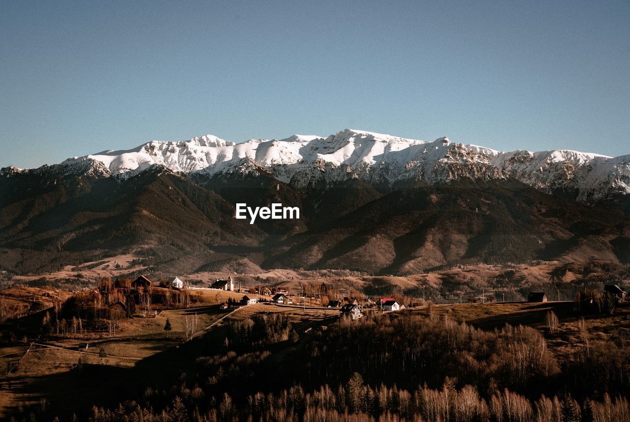 Scenic view of snowcapped mountains against clear sky