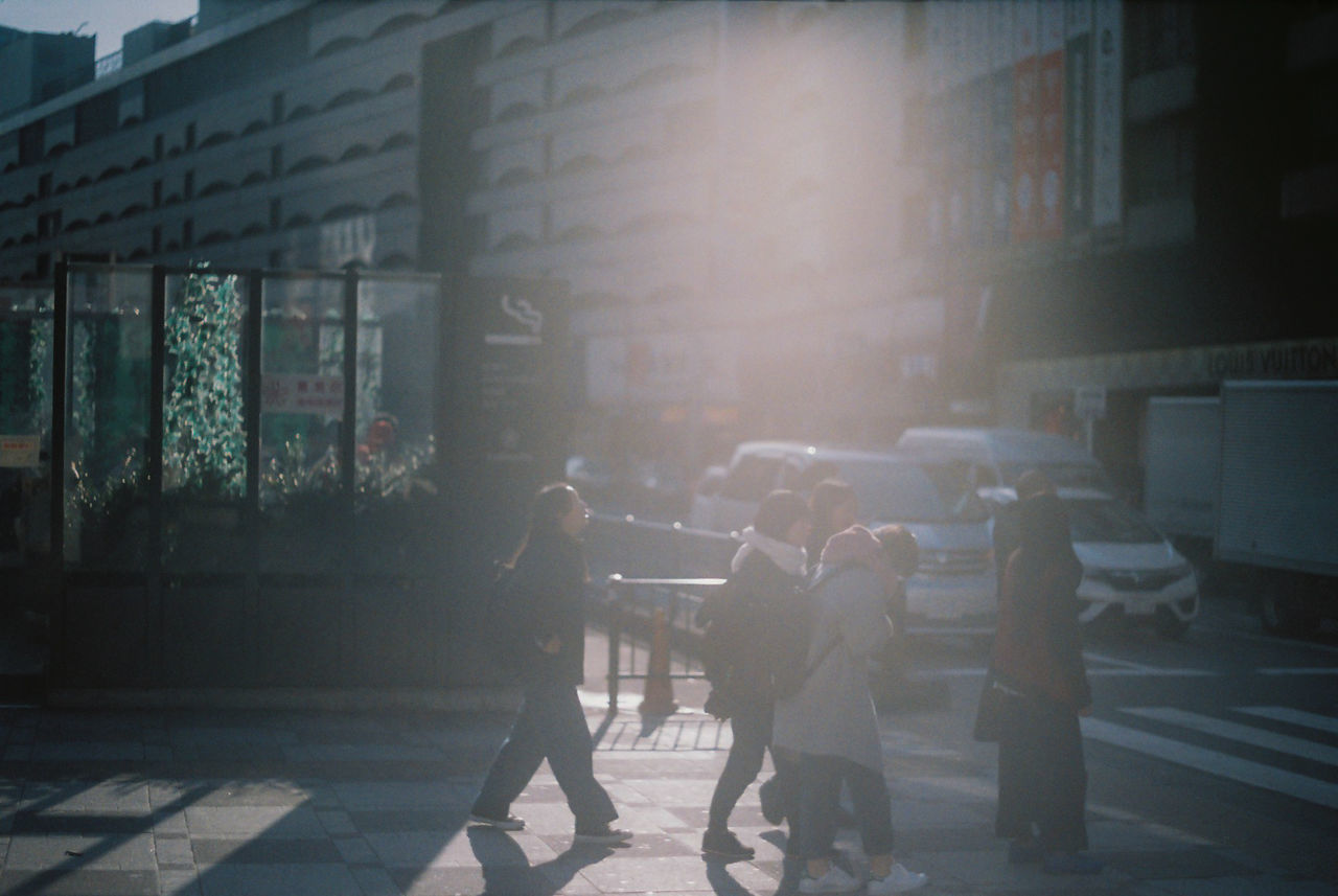 PEOPLE WALKING ON STREET IN CITY