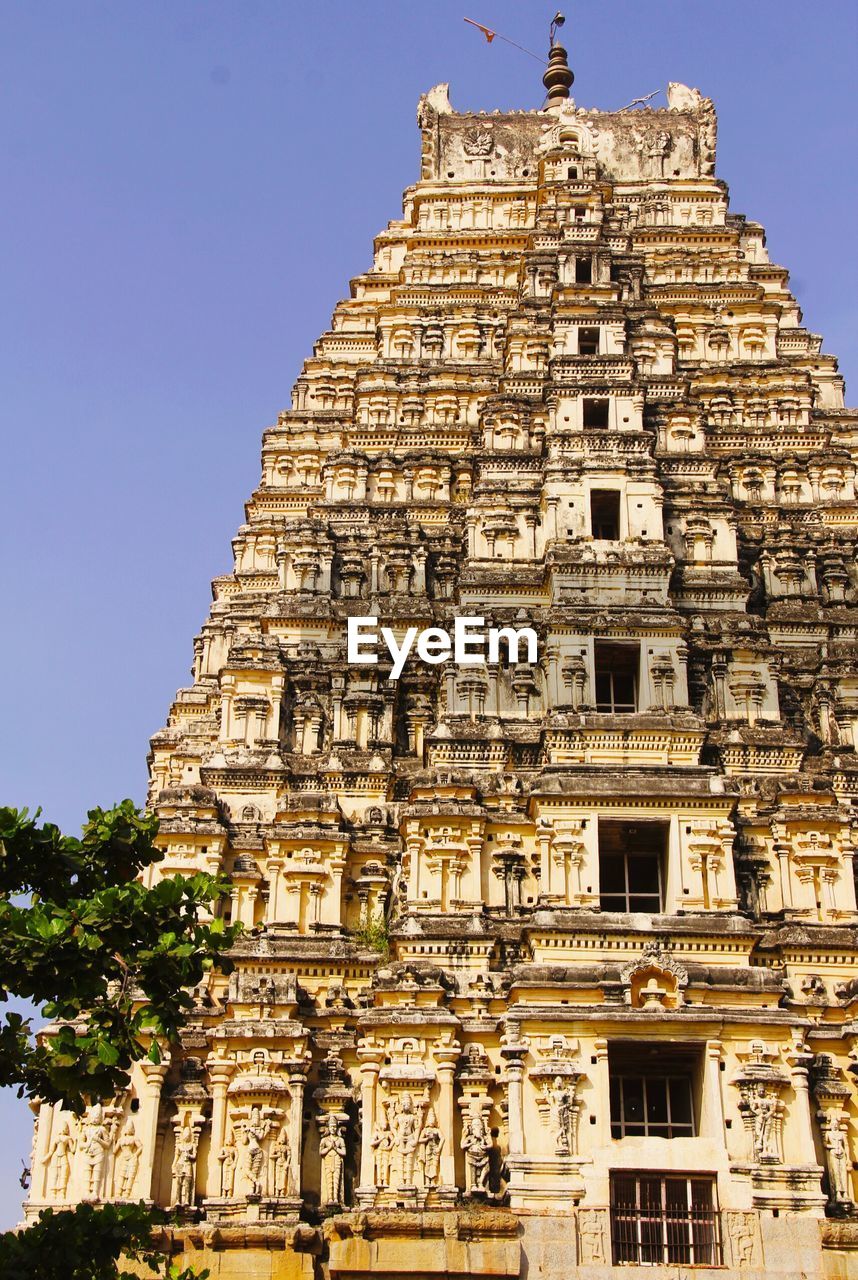 Low angle view of temple against blue sky