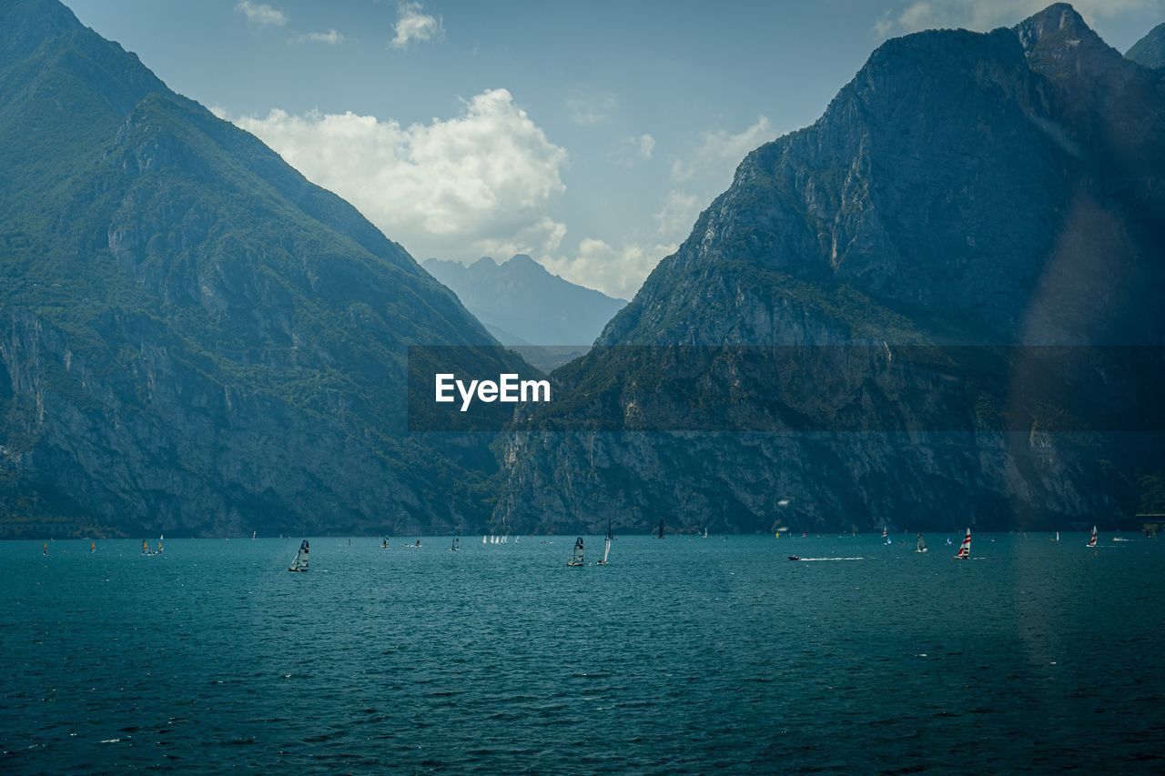 Scenic view of sea and mountains against sky