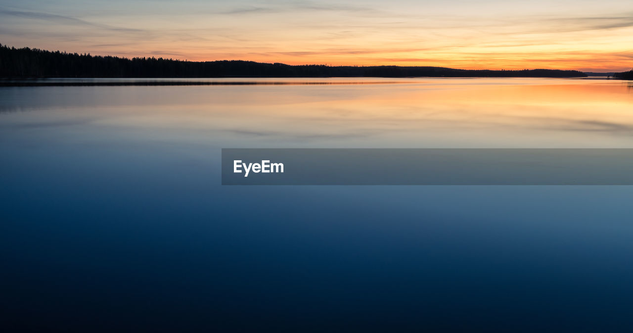 SCENIC VIEW OF LAKE DURING SUNSET