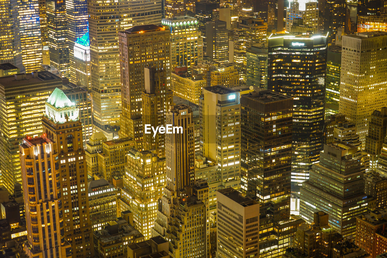 aerial view of illuminated buildings in city at night