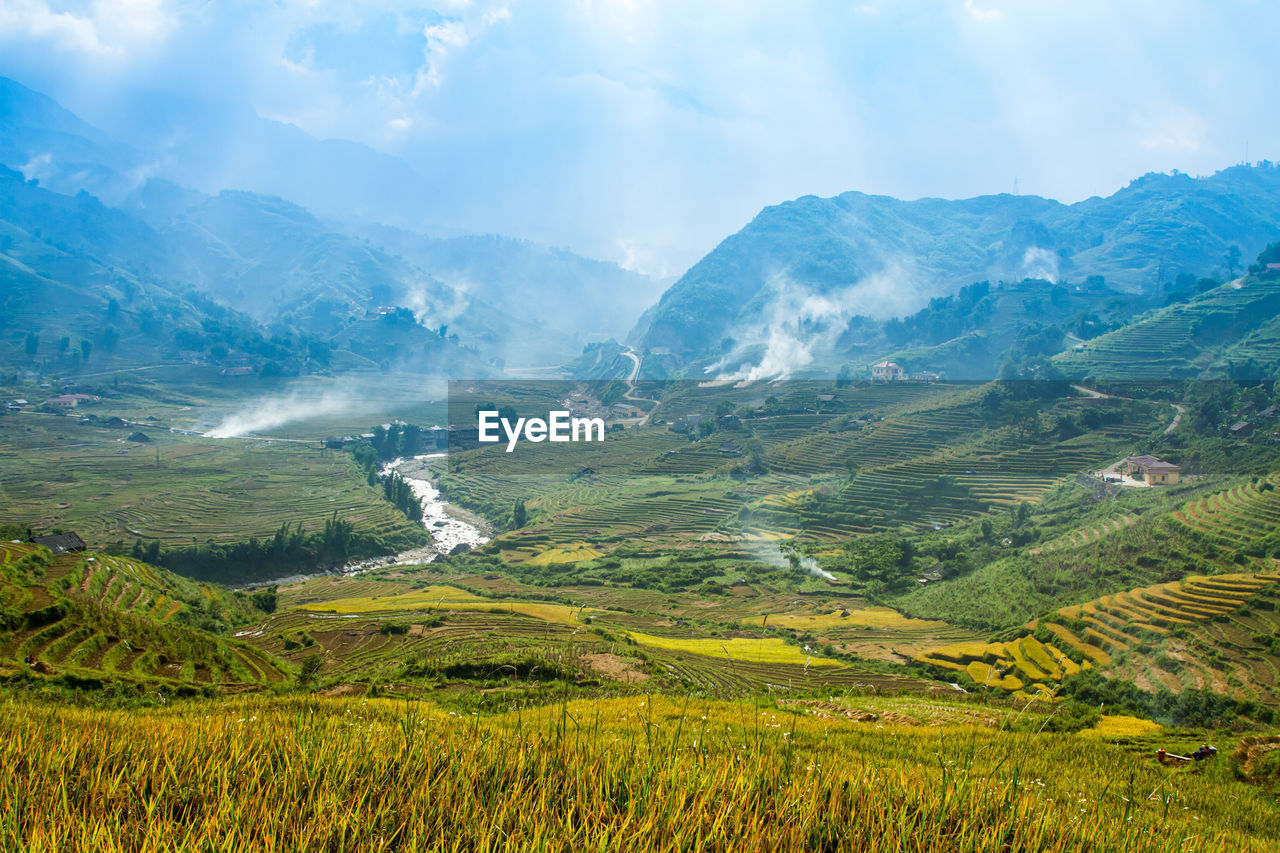 Scenic view of landscape and mountains against sky