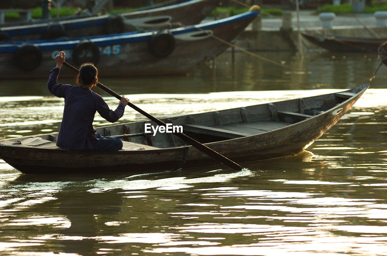 Man sitting on boat in river