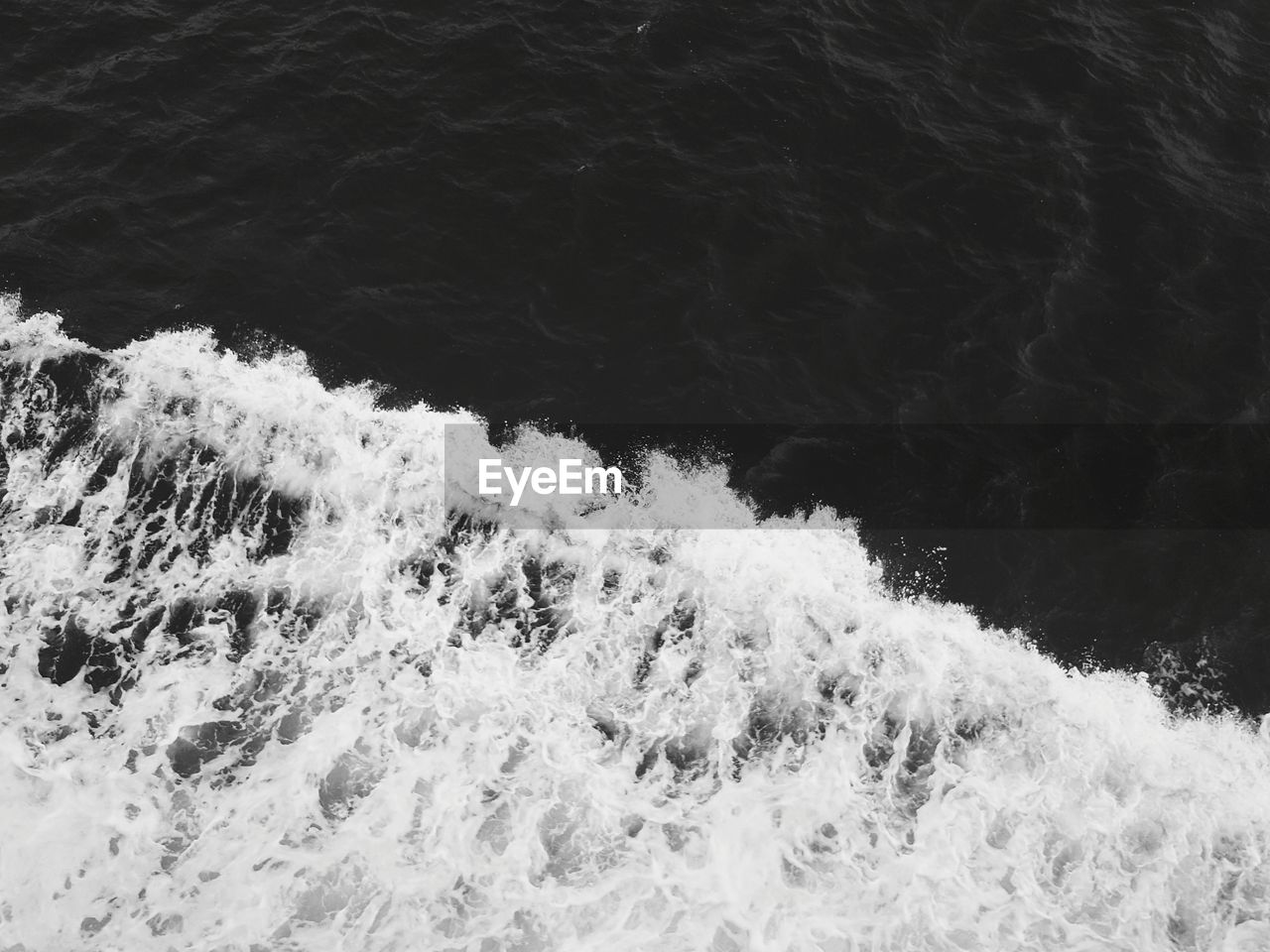 High angle view of waves splashing in sea