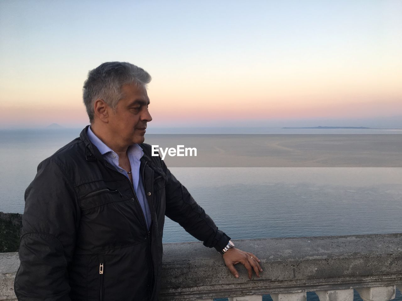 Man standing against sea during sunset