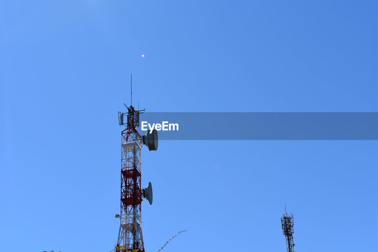 LOW ANGLE VIEW OF COMMUNICATIONS TOWER AGAINST SKY