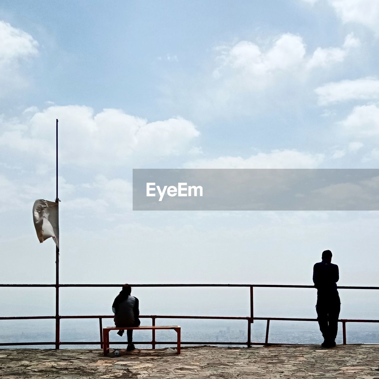 sky, cloud, sea, men, nature, two people, rear view, railing, adult, water, horizon, full length, lifestyles, beach, day, women, leisure activity, coast, ocean, silhouette, outdoors, togetherness, standing, copy space, beauty in nature, land, scenics - nature, tranquility, walkway, trip, vacation, holiday