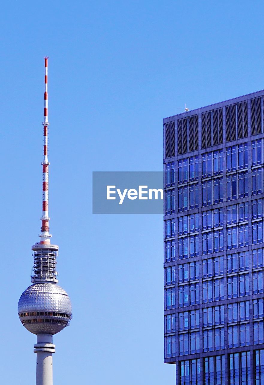 Low angle view of modern building against blue sky