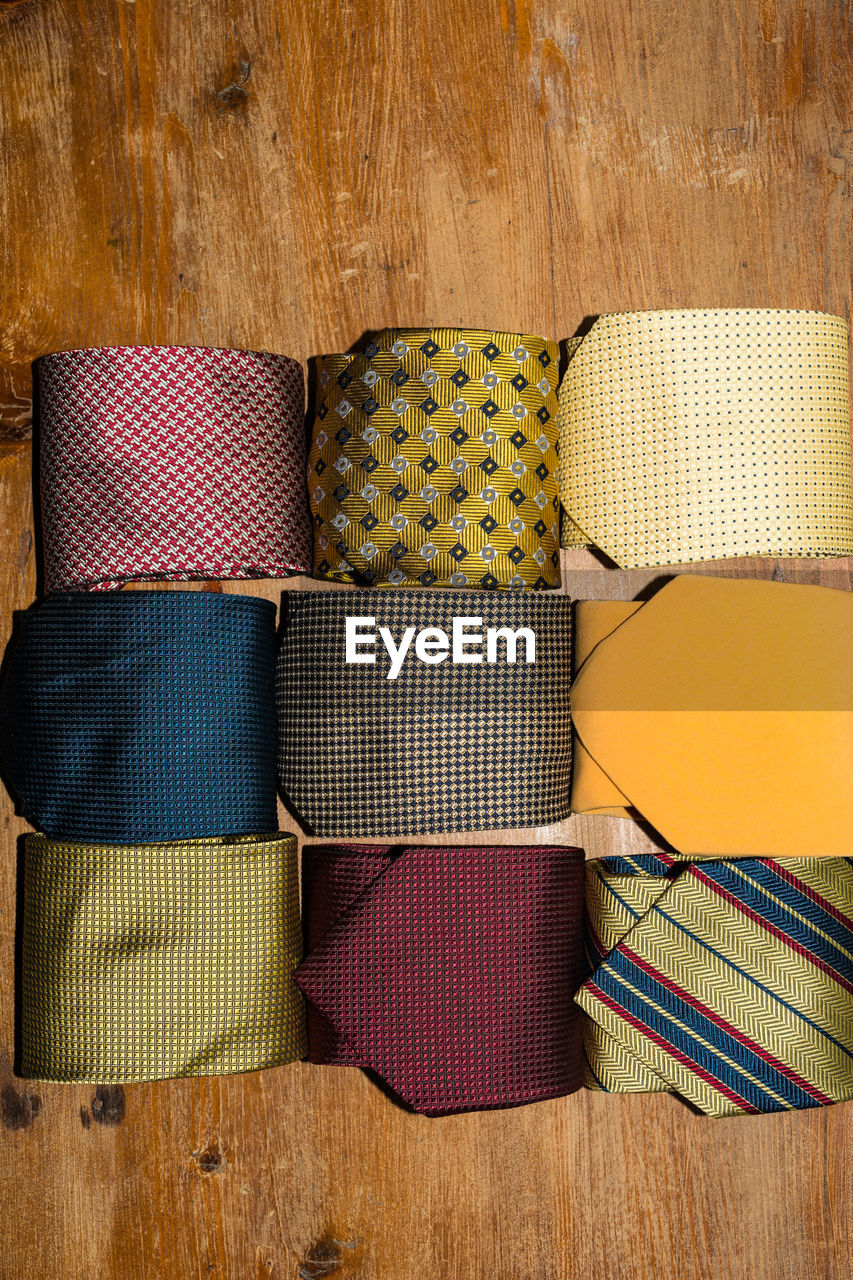 HIGH ANGLE VIEW OF MULTI COLORED UMBRELLAS ON WOODEN TABLE