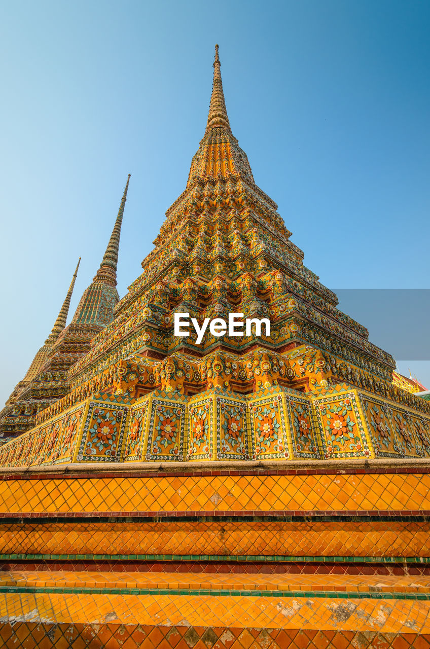 Low angle view of wat pho against clear sky