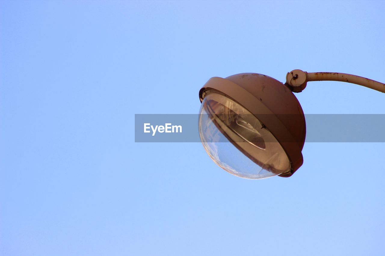 Low angle view of street light against clear blue sky