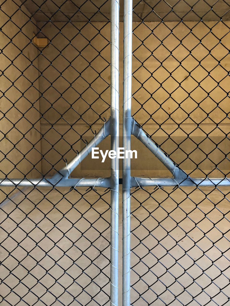 FULL FRAME SHOT OF CHAINLINK FENCE WITH METAL GRATE