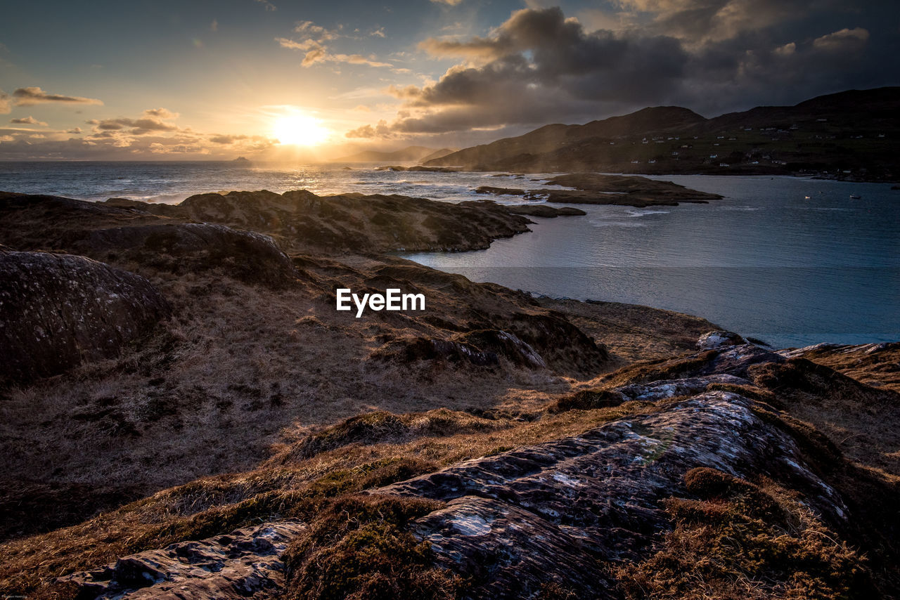 Scenic view of beach against dramatic sky