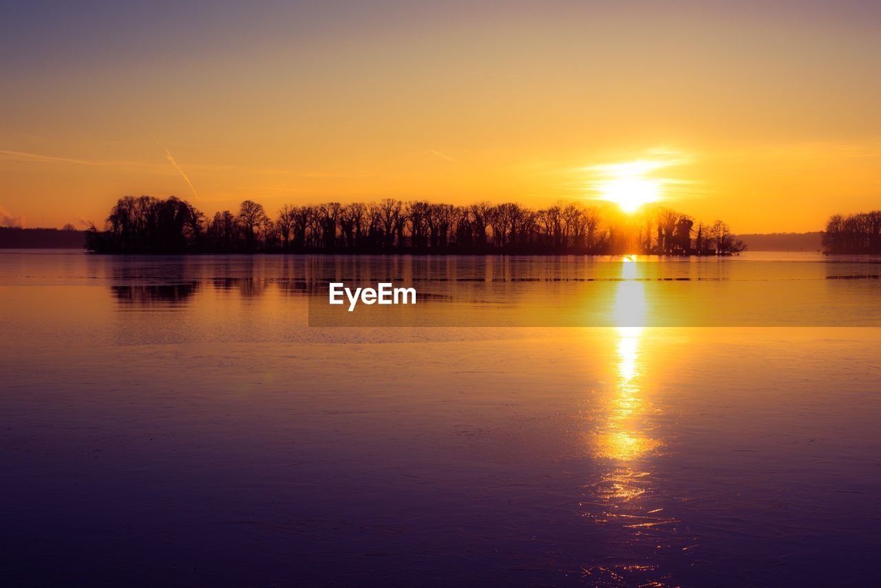 Scenic view of lake against sky during sunset