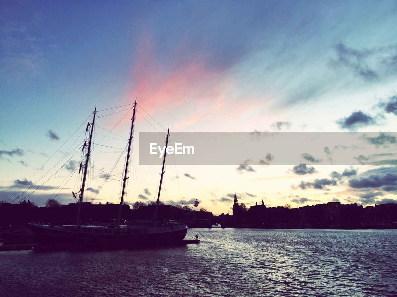 View of boat in calm lake against sky