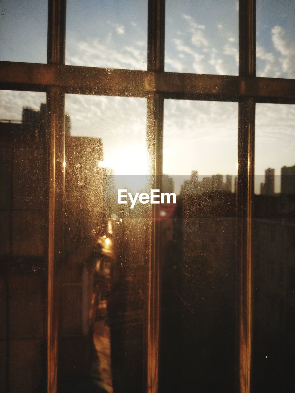 BUILDINGS SEEN THROUGH GLASS WINDOW