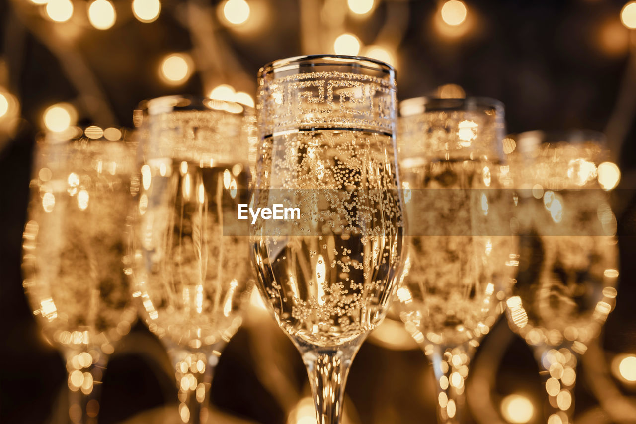 New year concept. glasses of champagne on dark background with lights