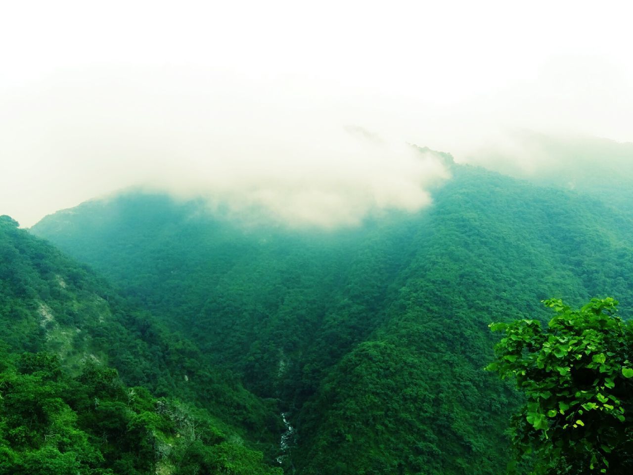 Scenic view of mountains against cloudy sky