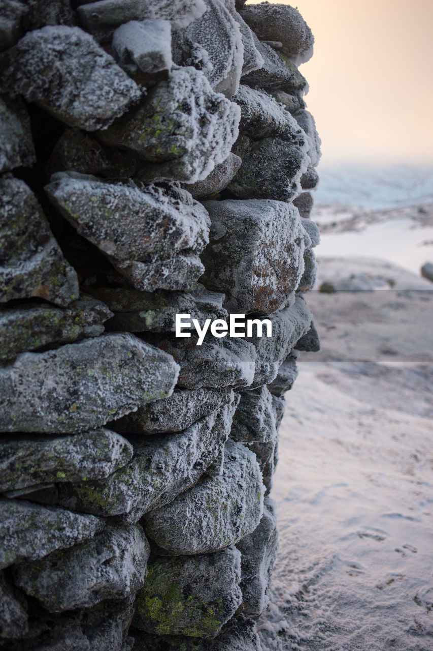 Stack of rocks on beach against sky