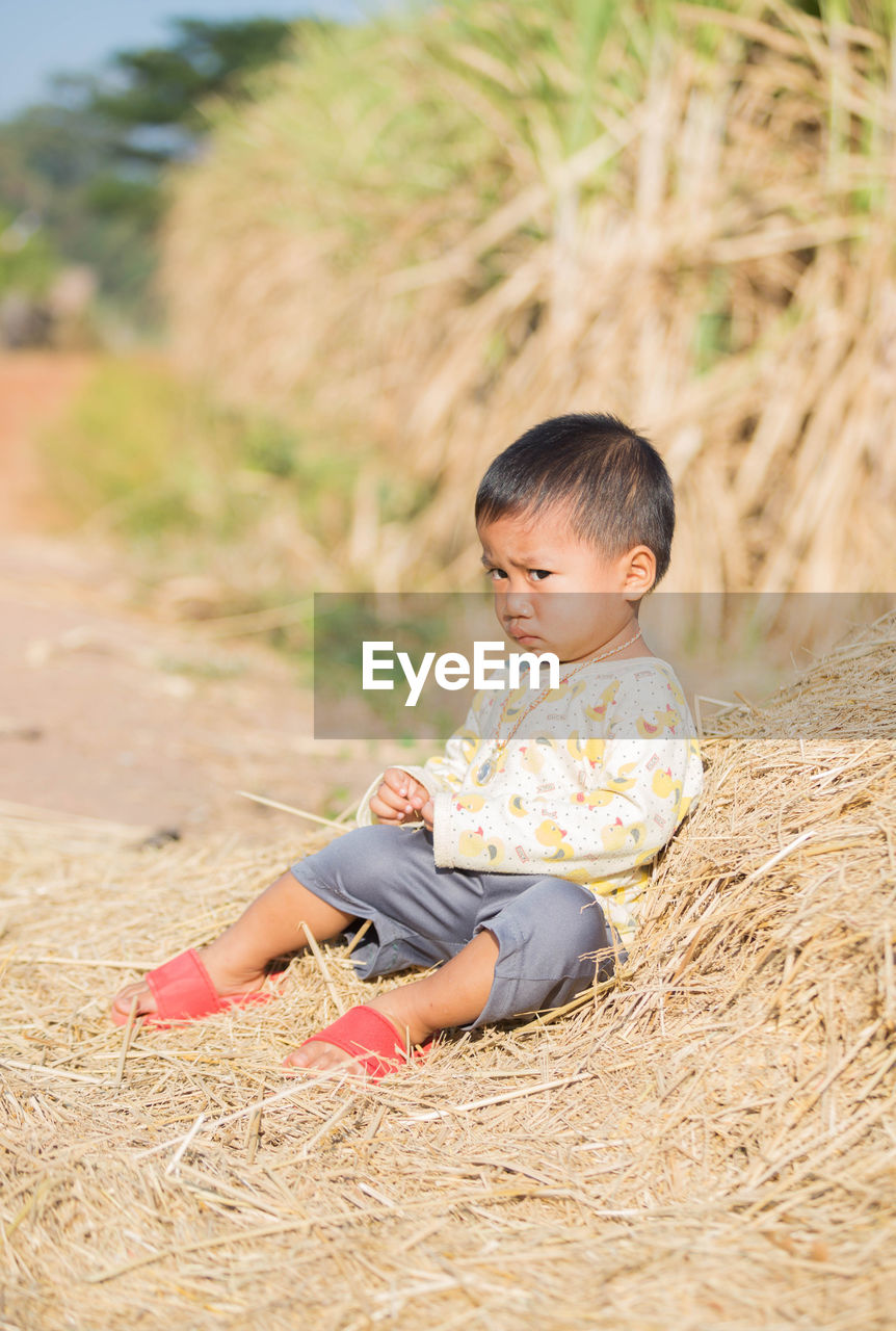 Boy sitting on field