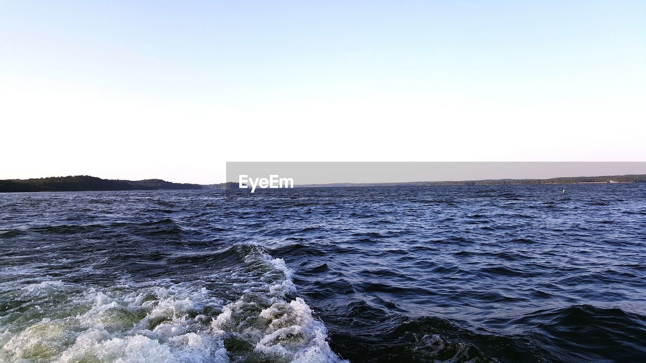 VIEW OF CALM SEA AGAINST CLEAR SKY