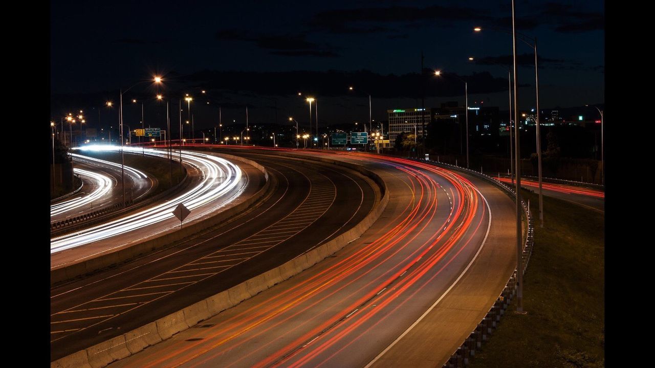 High angle view of light trails on road at night