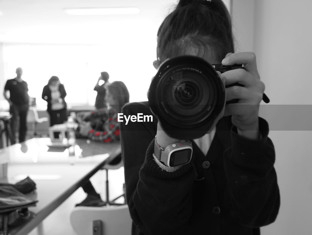 REAR VIEW OF MAN PHOTOGRAPHING WOMAN