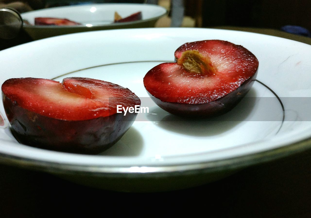 Close-up of plum in plate on table