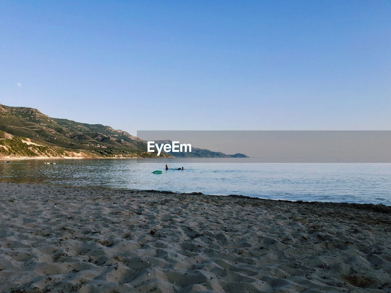 Scenic view of beach against clear sky