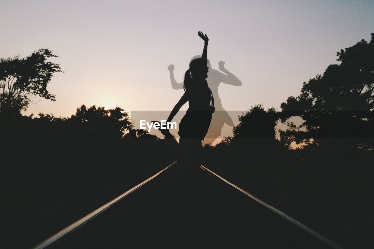 YOUNG WOMAN JUMPING IN PARK