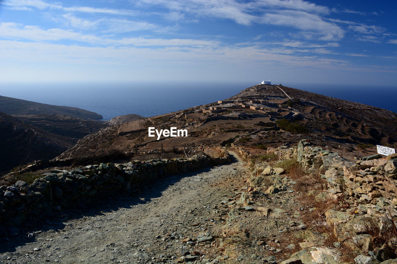 Scenic view of aegean sea by mountain against sky