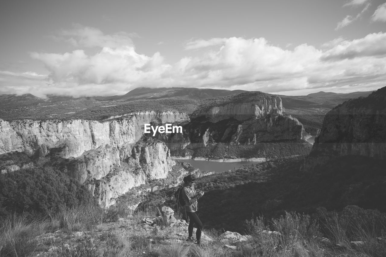 MAN ON LANDSCAPE AGAINST SKY