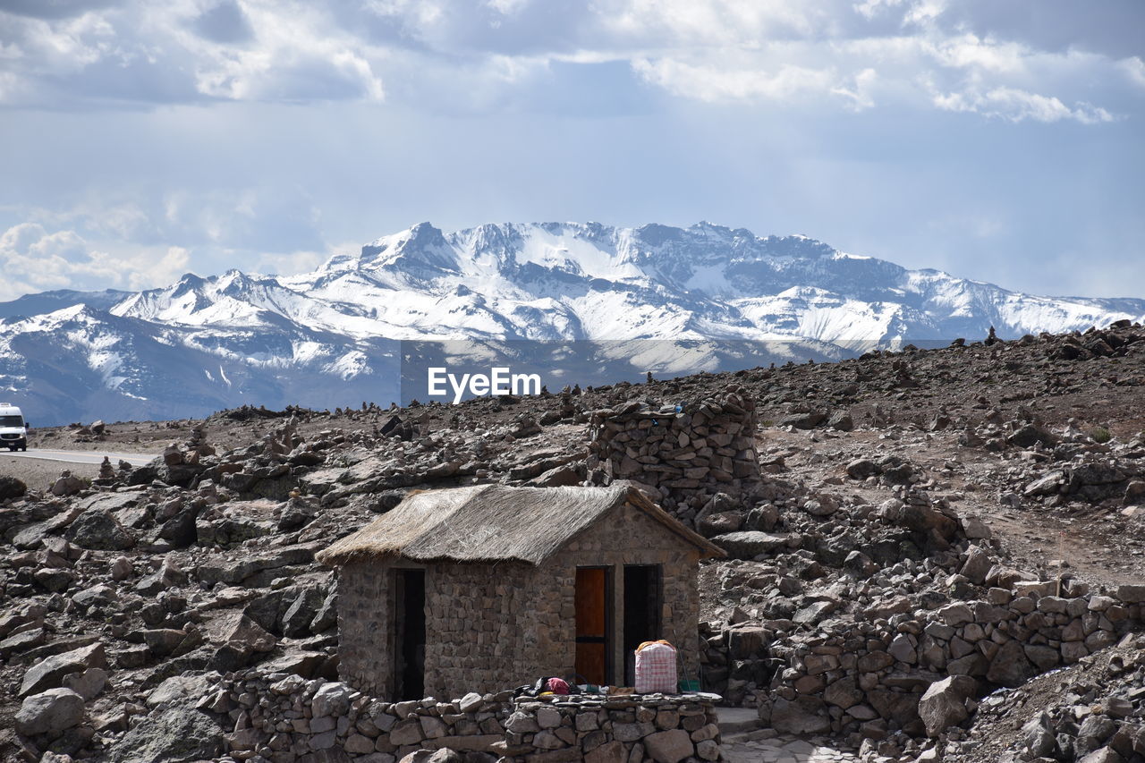 House on mountain against sky