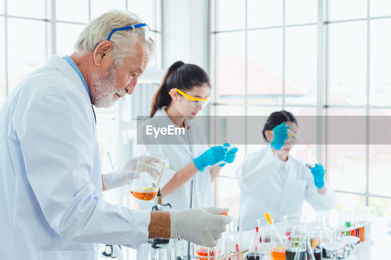 Man and women analyzing in laboratory