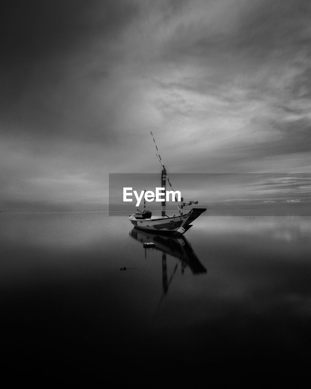 Fishing boat in sea against sky