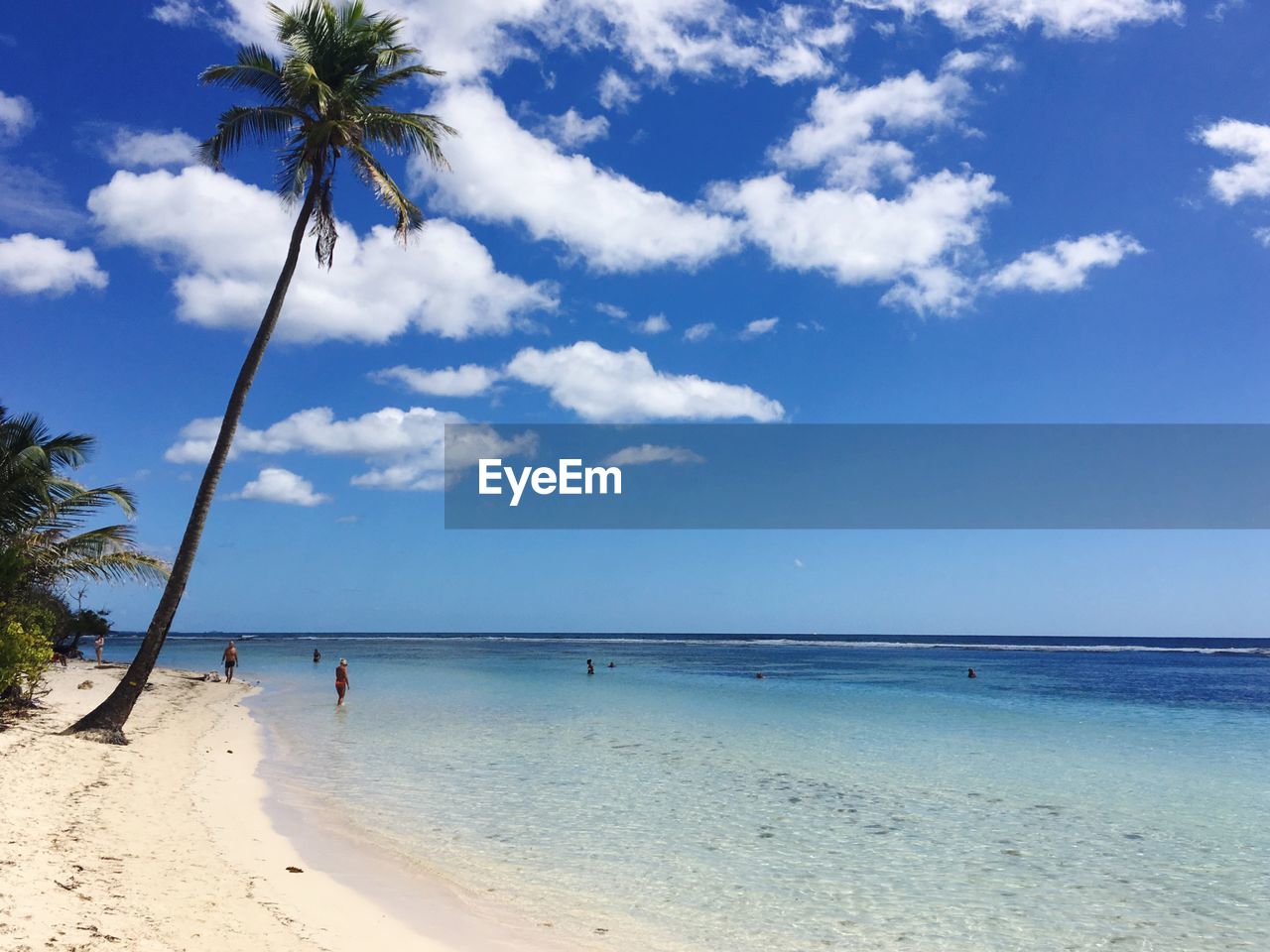 Scenic view of beach against blue sky