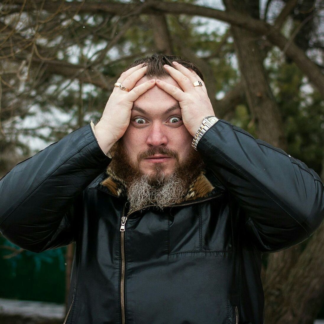 Portrait of frustrated bearded man against tree