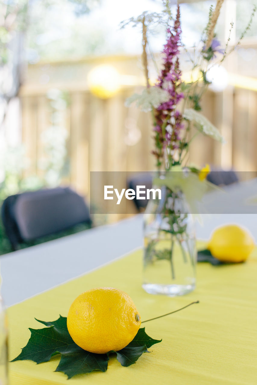 Close-up of lemon on leaf at table